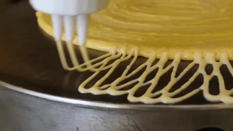 Close-up of Chef Squeezing Batter onto Crepe on Flat Griddle Stock-Footage 345692570