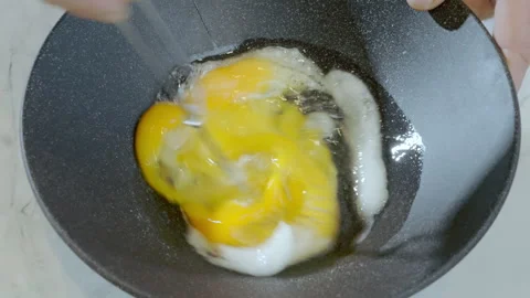 Close-up of a chef starting to beat a raw egg with sugar in a dark bowl. Stock Footage 308181426