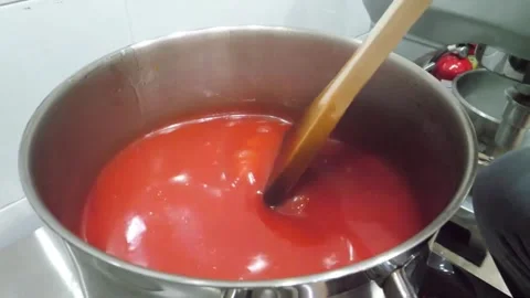 Close-up of Chef Stirring Concentrated Red Food Coloring into Liquid Base Stock Footage 345292035