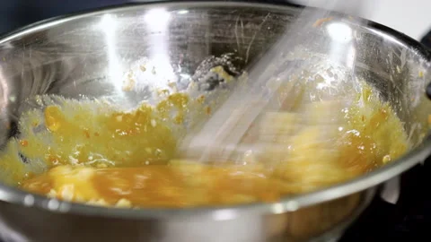 Close up of chef stirring the egg yolks and butter in a bowl. 4K Stock Footage 134813179