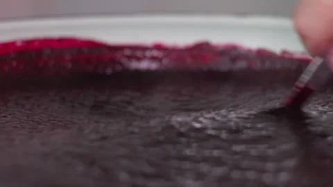 Close-up of a Chef Stirring Thick Berry Puree in a Glass Mixing Bowl Stock Footage 339630948