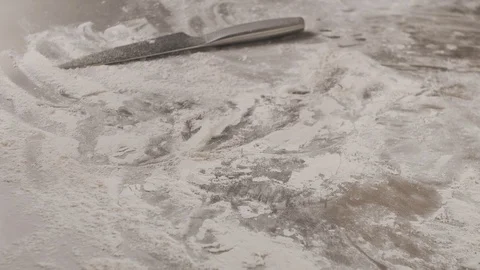 Close-up of chef throws fresh pita bread on table with flour. Slow motion video Stock Footage 114305576