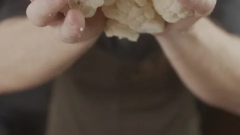 Close-up of chef tossing slices of cauliflower into blender. Slow motion video Stock Footage 123051823