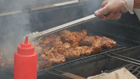 Close-up of a chef turns the meat, grilled steak and closes the grill Stock Footage 116025430
