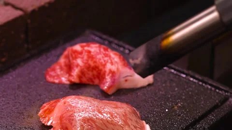 Close Up of Chef Using Blowtorch to Sear Wagyu Beef Sushi Stock Footage 326410598