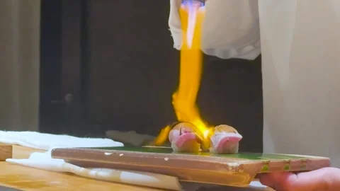 Close Up of Chef Using Blowtorch to Sear Fresh Nigiri Sushi Stock Footage 326847567