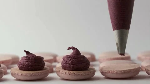 Close up of Chef using pastry bag to squeeze creamy berry filling Stock Footage 218119258