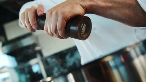 Close up: the chef is using pepper mill to add some pepper to food, pepper is Stock Footage 201927189