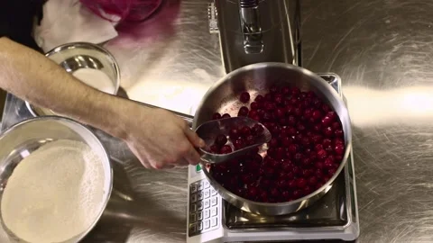Close up. A chef weighs cherries for baking a fruit pie or other desserts. Stock Footage 233296703