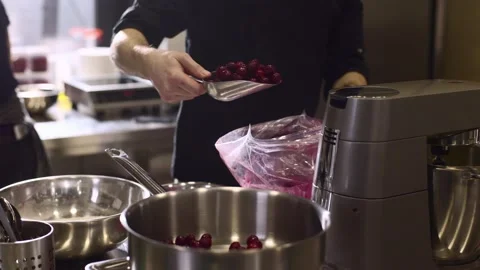 Close up. A chef weighs cherries for baking a fruit pie or other desserts. Stock Footage 233296727