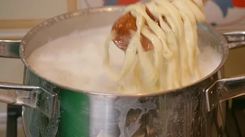 Close up of a chef while mixes the pasta in the boiling pot -  italian pasta Stock Footage 126316599