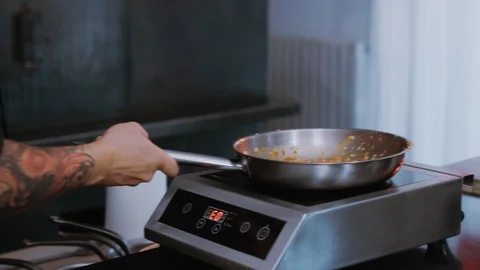 Close up of a chef working with flames roasting mixed colorful vegetables Stock Footage 100303926