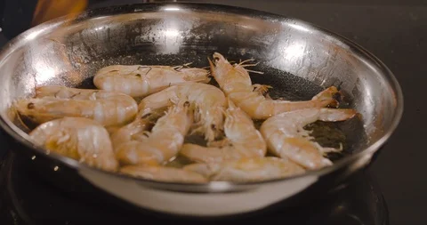 Close up of a chef working with flames shrimp in restaurant kitchen Stock Footage 124006338