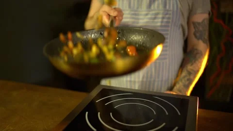 Close-up of a chef working the wok with flames roasting mixed colorful Stock Footage 192082998