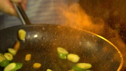 Close-up of a chef working the wok with flames roasting mixed colorful Video stock 192435277