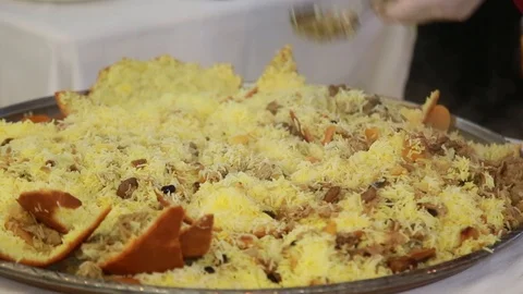 Close-up of a chef's chef cutting a knife firm dish - pilaf baked in bread Stock Footage 99366750