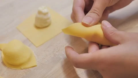 Close-up of chef's hand folding handmade pasta dough Stock-Footage 131146285
