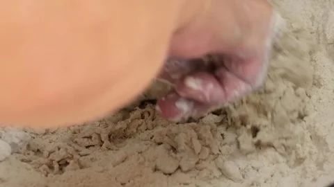 Close-up of Chef's Hand Mixing Flour and Water to Prepare Homemade Dough Stock Footage 333522315