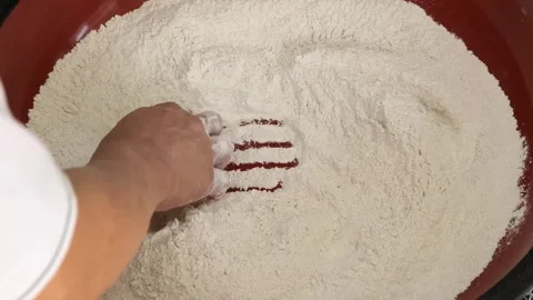 Close-up of Chef's Hand Mixing Whole Wheat Atta Flour in a Large Red Bowl for Do Stock Footage 333522275
