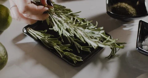 Close up of chef's hand is picking rosemary leaves in kitchen. Stock Footage 124001682