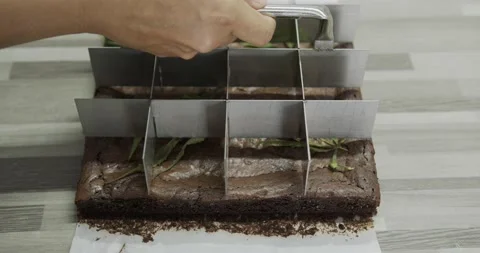 Close up, Chef's hand puts a pattern on the delicious brownies. Stock Footage 166828199