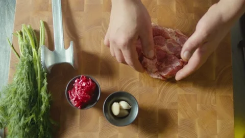 Close-Up of The Chef's Hands are Working With Meat on a Wooden Board. Top View Stock Footage 196256791