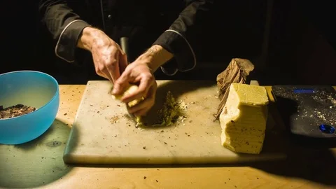 Close-up chefs hands chopping butter Stockbeeldmateriaal 79809096