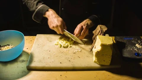 Close-up chefs hands chopping butter Video stock 79811619