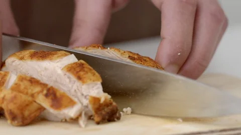 Close-up of a chef's hands that cuts meat cooked on a grill in slow motion Stock Footage 94120649