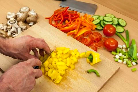 Close up of a chefs hands dicing a yellow bell pepper Stock Photos