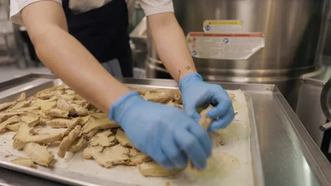 Close up chefs hands with ginger on baking tray, restaurant kitchen Stock Footage 258808056