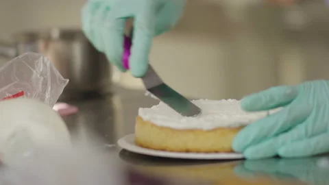 Close-up, Chef's Hands in Gloves Smear Cream on Cake Stock Footage 140725496