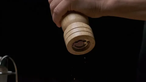 Close-up of a chef's hands grinding pepper with a pepper mill Stock Footage 138724650