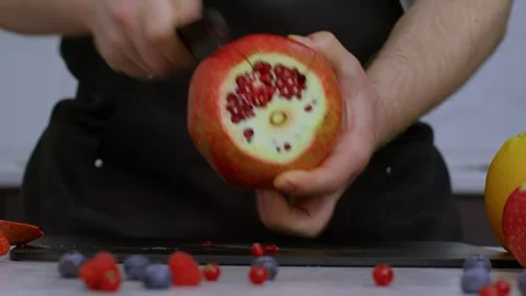 Close-up of a chef's hands peeling a delicious pomegranate. A healthy fruit full Stock Footage 269123291