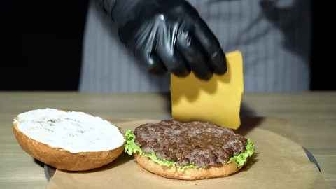 Close-up of the chef's hands preparing the burger. Stock Footage 115837058