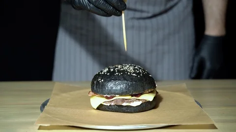 Close-up of the chef's hands preparing the burger. Stock Footage 115838366