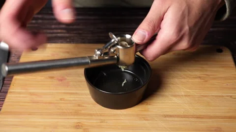 Close up of a chef's hands pressing garlic with a garlic press. Stock Footage 301444311