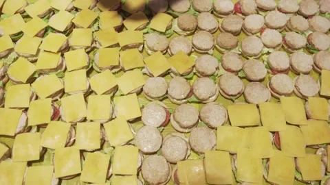 Close-up of a chef's hands putting cheese on buns. Preparing a lot of sandwiches Stock Footage 171915689