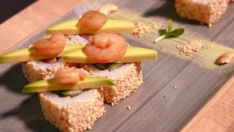 Close-up of chef's hands putting shrimp on top of sushi. Stock Footage 269557998