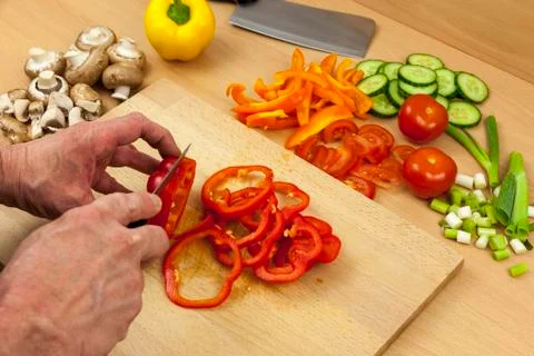 Close up of a chefs hands ring slicing a red bell pepper Stock Photos