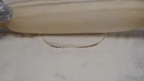 Close-up of chef's hands rolling out small circles with rolling pin. Stock Footage 313973043