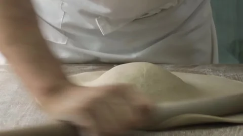Close-up of Chef's Hands Rolling Out Fresh Pizza or Pastry Dough on Floured Surf Stock Footage 333522743
