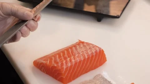 Close-up of Chef's Hands Slicing Fresh Salmon Fillet for Sashimi Preparation Stock Footage 333489644