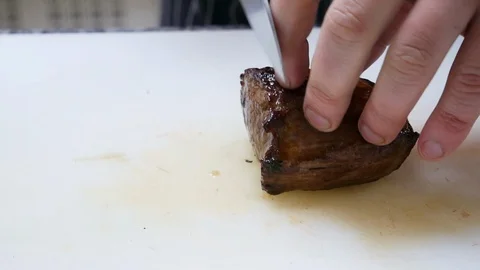 Close-up of chef's hands, which cuts meat, medium rare steak Stock Footage 107191613