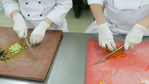 Close up of chefs slicing fresh celery and pepper on a wooden chopping board Stock Footage 106187038