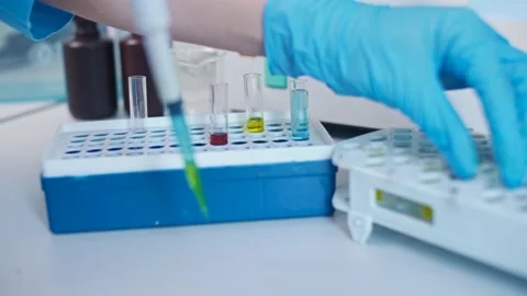 Close-up Chemist Mixed up Chemicals Using a Micropipette. Developers of Stock Footage 154028342