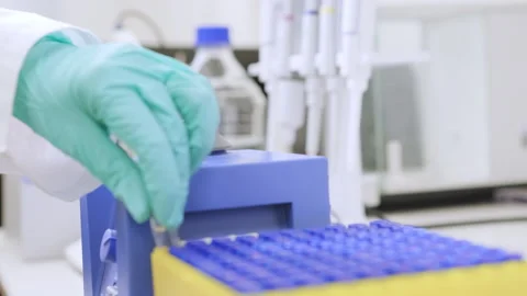 Close up of a chemist shaking samples using a vortex mixer before HPLC analysis Stock Footage 280059065