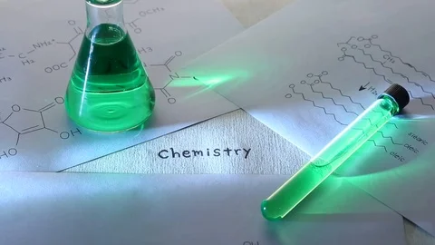 Close up of chemistry text on laboratory table, conical flask and test tube Stock Footage 95967644
