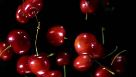 Close-up Of Cherries Bouncing On Black Background Stock Footage 119924955