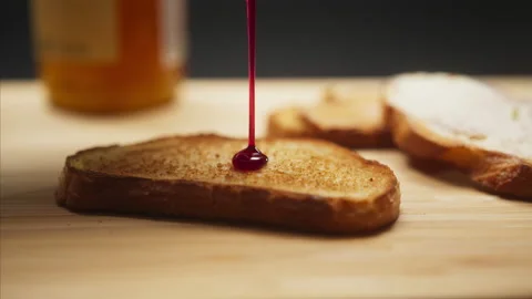 Close-up of cherry jam on slice of toast bread, breakfast food meal or snacks 스톡 동영상 144629986